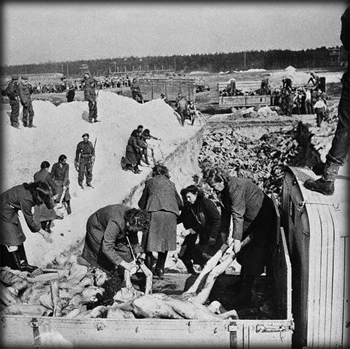 S.S. women removing bodies from lorries into a communal grave 